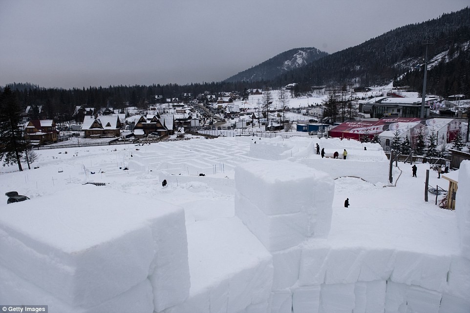 More than 40 mountaineers are cutting 60,000 snow cubes and manually placing them to create the labyrinth